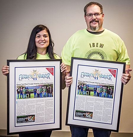 Jammi Juarez, left, and Casey Salkauskas show the framed copies of The Electrical Worker that features their organizing work in Illinois. Photo by John Storey
