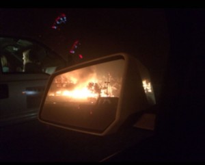 Jessica Smith captured this photo in her rear-view mirror as her house burned down in front of her eyes.