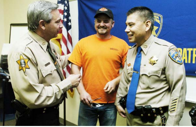 Joe Heberline, center, and Merced  County Sheriff Mark Pazin, left, are  recognized for their heroics by CHP  Commissioner Joe Farrow in a special  awards ceremony on March 6. Sun-Star  photo by George MacDonald.