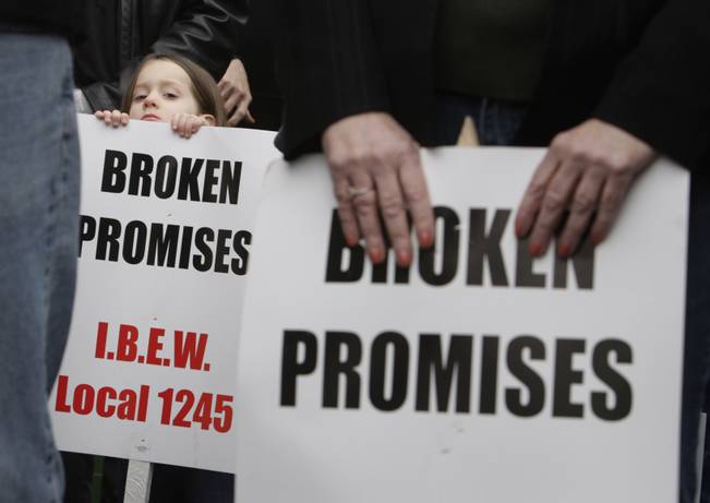Jasmine Cady, 4, peeks over a sign as she attends a protest rally with her father, an International Brotherhood of Electrical Workers union member, outside NV Energy headquarters on Tuesday, Feb. 9, 2010. Retired NV Energy employees from northern Nevada were joined by local IBEW and Culinary Union members for the rally. At issue are health benefits for retired workers and possible cuts to the current workforce. 