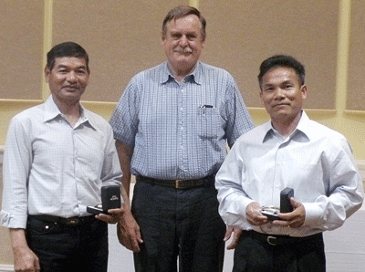 Soeun Khiev, left, and Saun Khiev, right, receive their watches from Business Representative Carl Lamers in Petaluma.