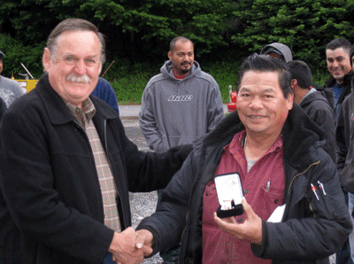 San Khiev, right, receives his watch from Business Representative Carl Lamers.