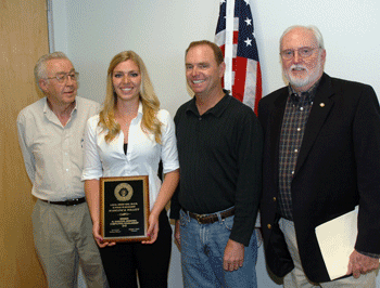 President Mike Davis, left, presents a plaque to winning essayist Madeline Willett. Standing next to Madeline is her father, Richard Willett. Former Business Manager Jack McNally, right, served as judge.