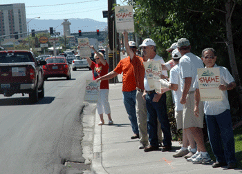 IBEW retirees picket an NV Energy Board of Directors meeting at the Peppermill Casino in Reno. Many passersby honked and waved their agreement with the "Shame on NV Energy" message.