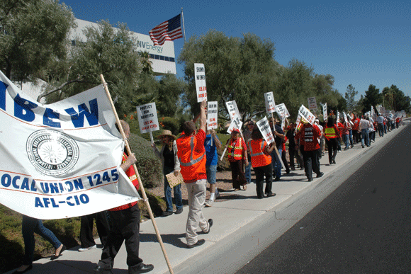 About 125 Local 1245 retirees and supporters march to the front entrance of NV Energy corporate headquarters in Las Vegas.