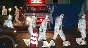 Workers in radiation protection suits prepare for the decontamination of two nuclear plant workers exposed to high levels of radiation.