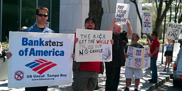 IBEW Local 1245 member Charley Souders joins the protest at Bank of America in Tampa. Local 1245 members are in Florida to build organizing skills while building bridges of solidarity to unions currently under attack.