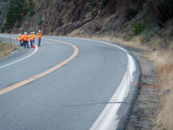 ote: The narrow edge of the roadway with the drop-off to the dirt shoulder and the skid marks