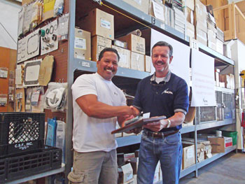 Murray Grande, Plant Manager, congratulating Frank Aguon on his retirement after 27 years.