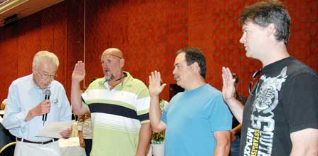 Three new members of the Advisory Council were sworn in. From left: President Mike Davis administers the oath to Jeff Campodonico, representing PG&E Sacramento; Keith Jacques, representing Citizens Communications (Frontier); and Avery Clifton, representing PG&E’s old Drum Division.