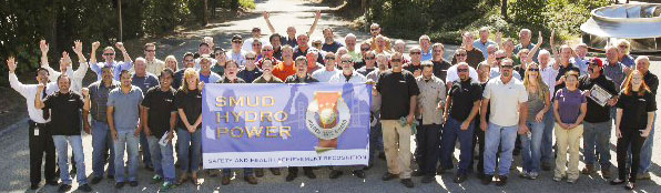 SMUD’s hydro employees proudly hold aloft their Golden Gate award banner.  Photo by Jonathan Knox