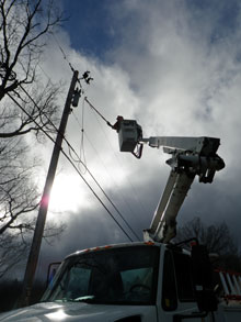 A Canadian line crew restores power in Rutland, VT.