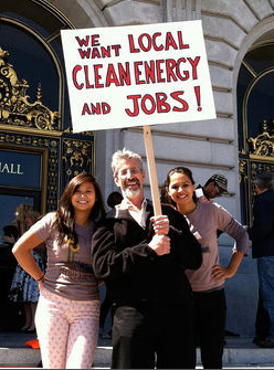 Al Weinrub, seen here with Bay Localize interns Michelle Woo (left) and Tatiana Chaterji, likens the PUC’s approach to CleanPowerSF to opening up a business and then devising a business plan. Photo by Corrine Van Hook