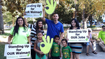 From left are Jammi Juarez, Rey Mendoza and family, and Georgette Carrillo Jonas at the Sept. 5 Wal-Mart action.