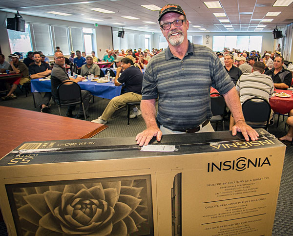 Bob Stout won the top raffle prize–a 55-inch LED television. 