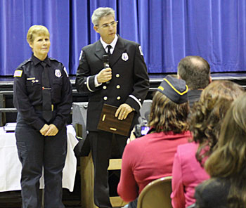 LMUD Fieldman Cindy Elliott, left, receives honor from Lt. Scott Head of the Susanville Volunteer Fire Department. 