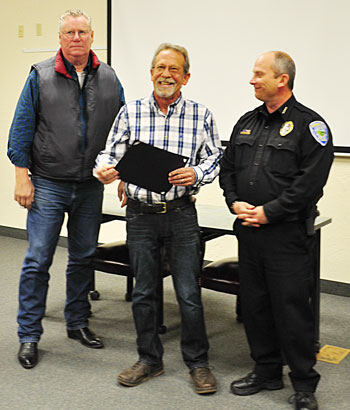 LMUD Troubleman Craig Lima, center, is honored by Susanville Mayor Rod DeBoer, left, and Susanville Chief of Police Tom Downing. Photos courtesy of LMUD.