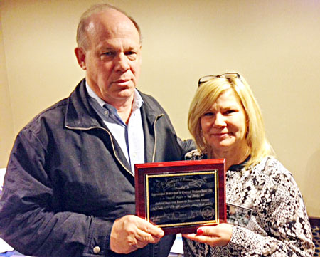 Terry Risse of the National Sisterhood United for Journeymen Linemen presents a plaque to Business Manager Tom Dalzell in recognition of IBEW 1245’s support of the Sisterhood, including participation in the Sisterhood’s national rodeo. The NSUJL raises money to provide support for families affected by a lineman’s death or serious injury on the job. 