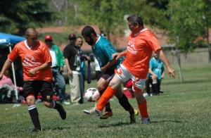 Players from Bakersfield (in orange) and Angels Camp (in teal) battle it out in the finals