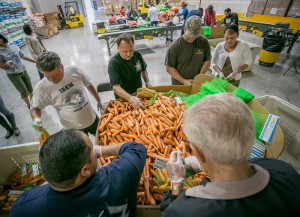 Bagging carrots for needy families