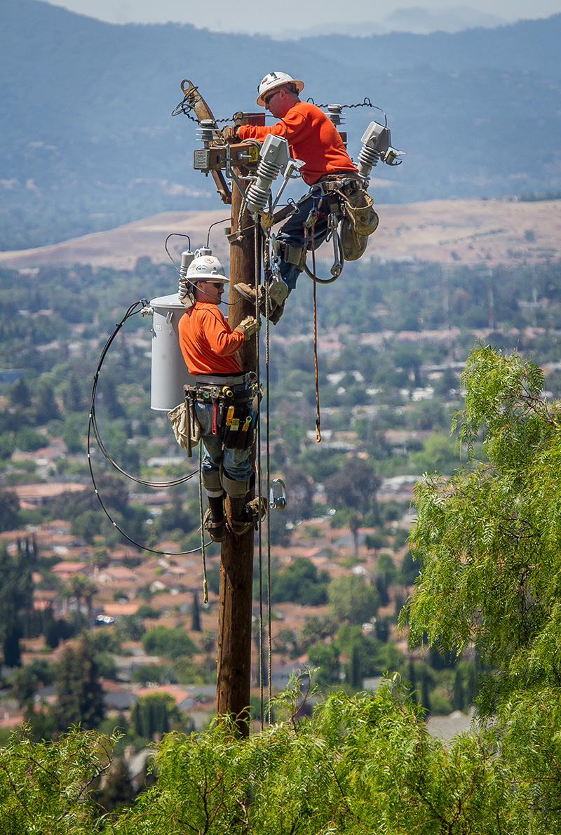 Apprentices Tim Fisher and Josh Ganthier wire up the new pole