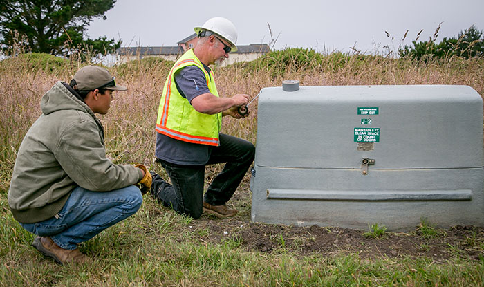 Brian Speelman and  Utility Worker Brandon Craig repair a junction box at the Shelter Cove golf course 