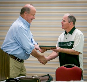 Chip Chadwick accepts a plaque of appreciation from Business Manager Tom Dalzell.
