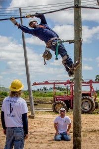 IBEW 1245 linemen Joe Baker and Carl Kheen (standing) supervise as a Surinamese lineman practices a new skill