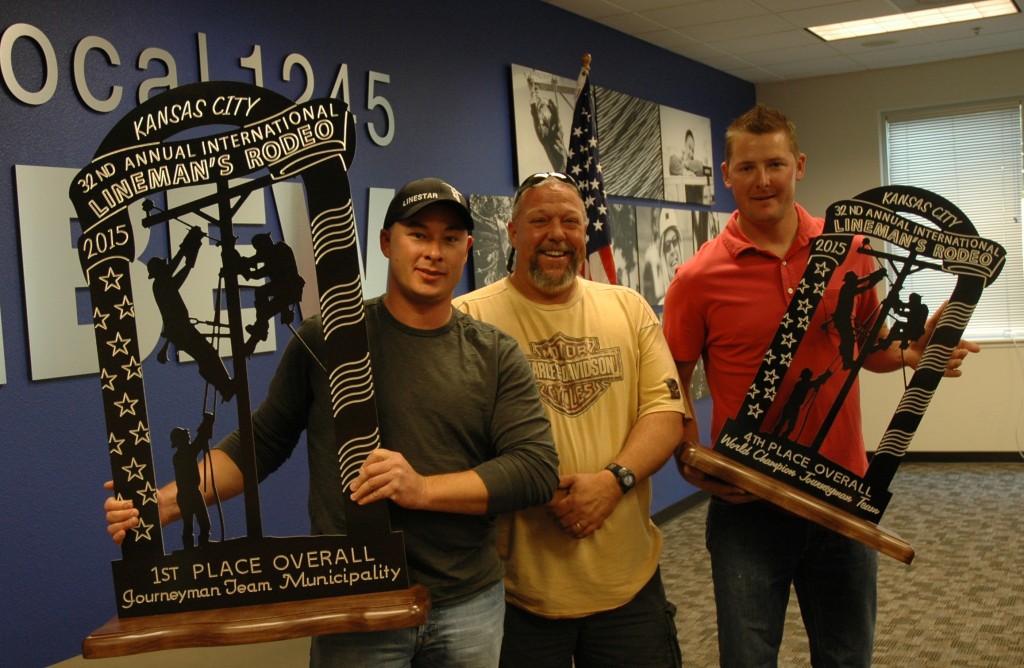 TID Advisory Council representative Craig Tatum (center) joins Rodeo champs Josh Klikna and Dustin Krieger as they show off their trophies