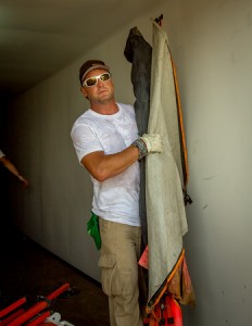 James Scott unpacks flags sent from Local 1245 for the lineman training in Paramaribo, Suriname 