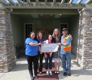Organizing Committee members delivered a check to Hospice of the Foothills 