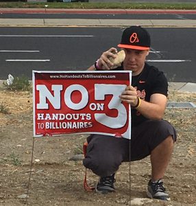 Local 1245 member Michelle Benuzzi's son used a rock to put up a No on Question 3 lawn sign