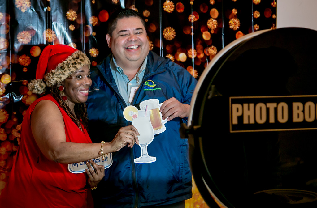 Livian Ellis & Sergio Caldera pose in the photo booth at the holiday party after the contract vote