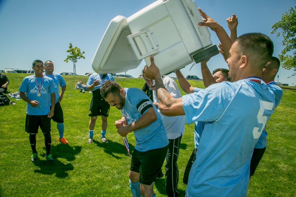 The winning team from Utility Tree of Angels Camp douse their captain with ice water at the IBEW 2017 Soccer Tournament in Ripon, Calif., on April 29th, 2017.