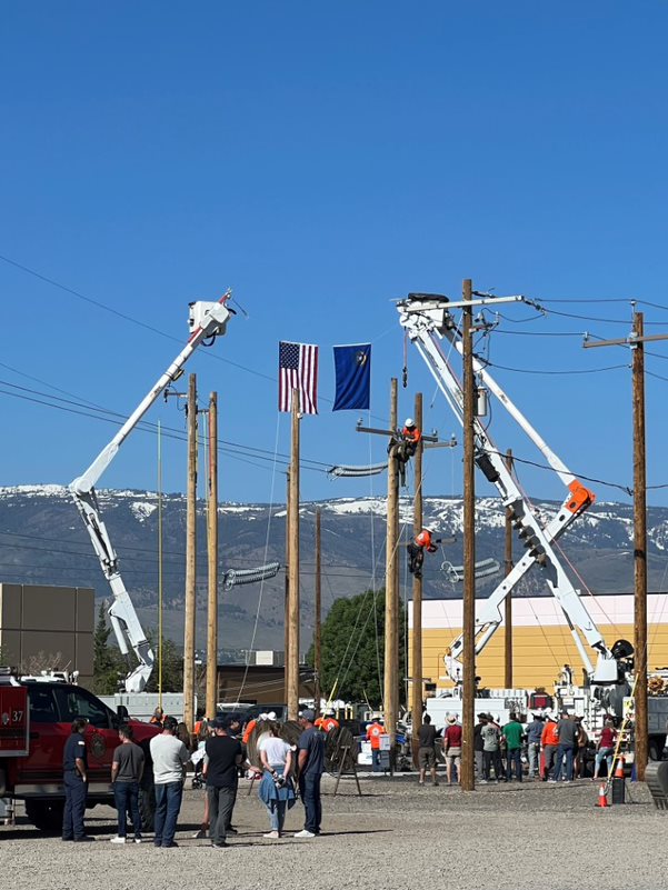 Spectators watch as linemen compete in the Rodeo