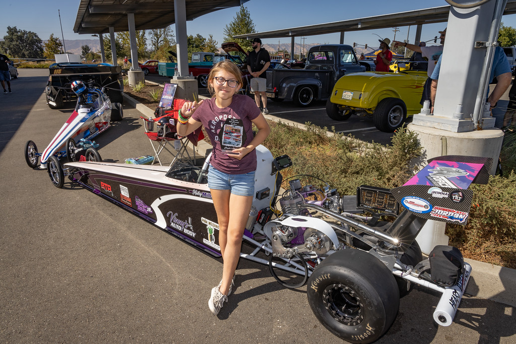 12 year old Hailey Miller, winner of the People's Choice award, in front of her dragster. 