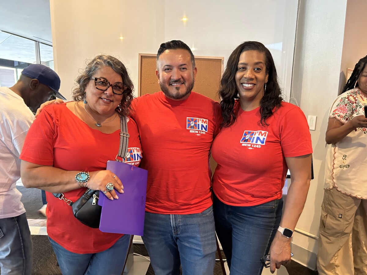 IBEW Business Representative Kim Camatti smiles with Assistant Business Manager Rene Cruz and Organizer Charlotte Stevens 