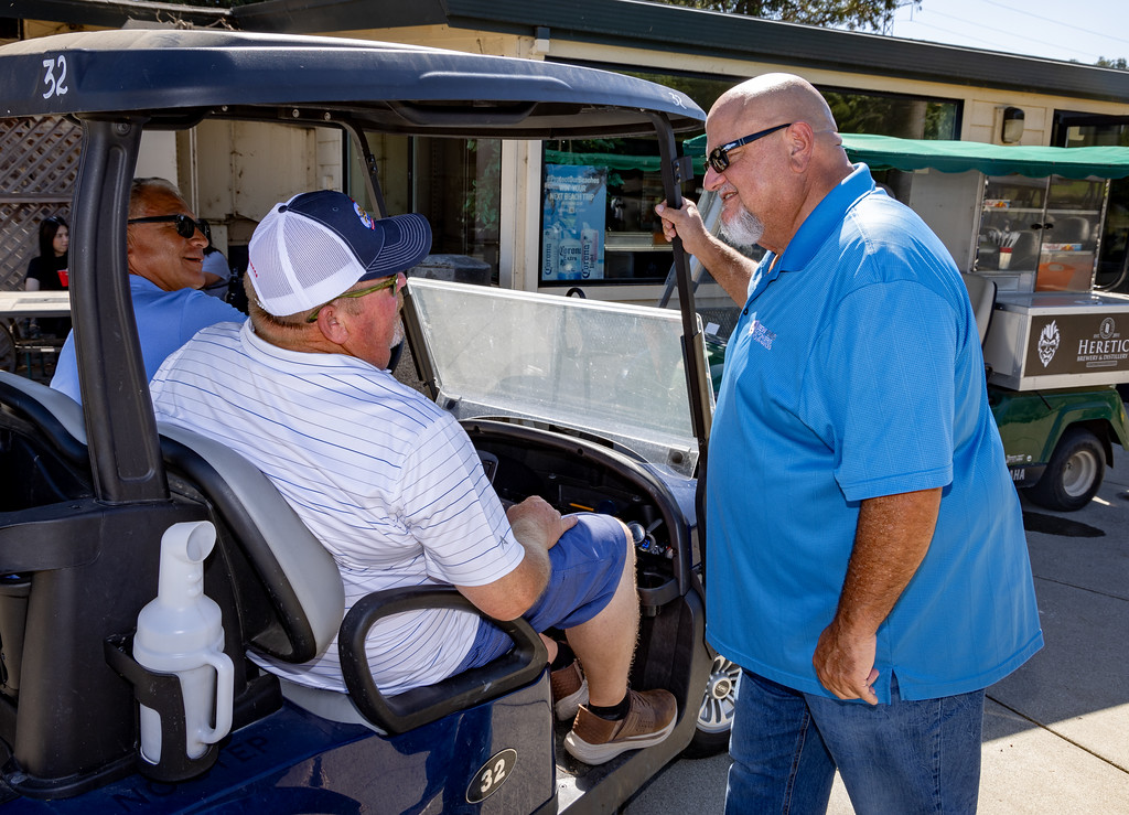 Business Manager Bob Dean greets the golfers