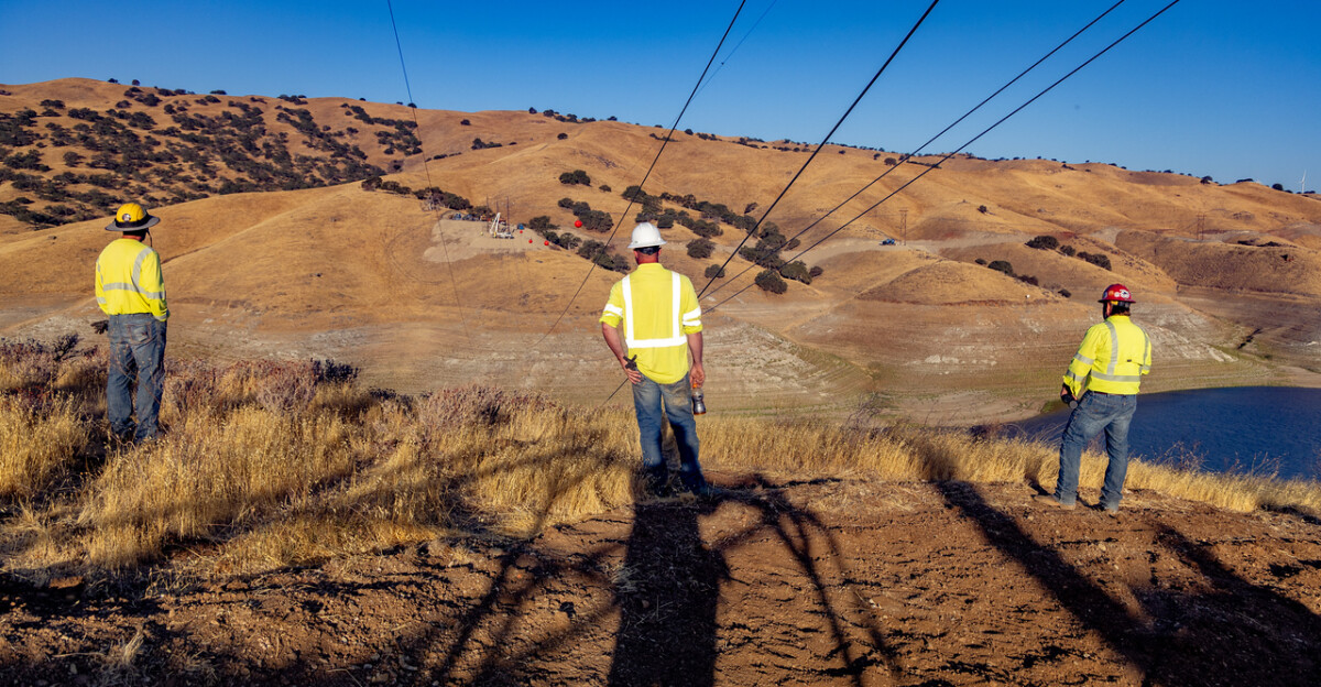 Crews work methodically to string wire over the reservoir at the Gonzaga Ridge Wind Project.