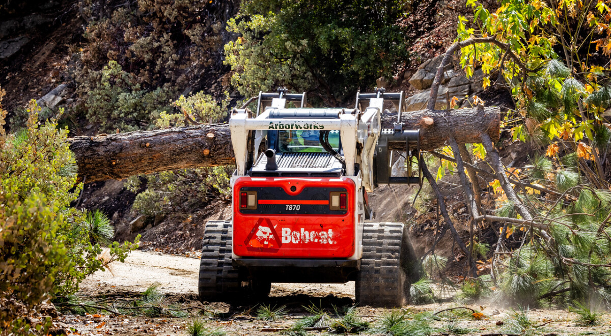 Sean McLinden maneuvers heavy equipment to clear a downed tree